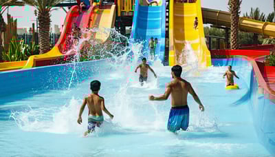 Families enjoying water park attractions in Dubai under the sun Families enjoying water park attractions in Dubai under the sun